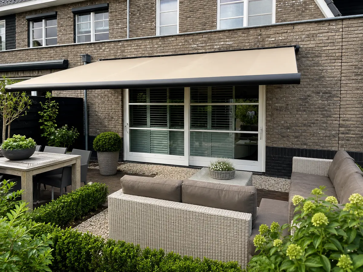 Sunmaster SunEye II knikarmscherm met zandkleurig doek boven een terras